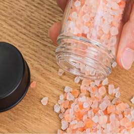 Rotating spice rack set designed to organize and store various spices. This spice rack appears to have a rotating carousel design, allowing easy access to different spices.